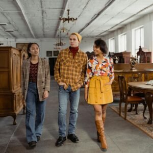 Diverse group of young adults exploring an antique store's interior, showcasing vintage furniture.