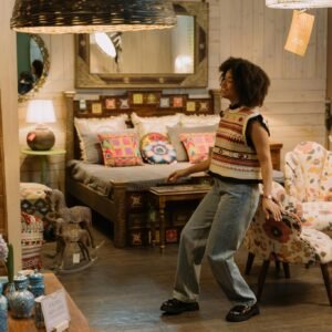 Woman in a boutique enjoying casual fashion with colorful decor around her.