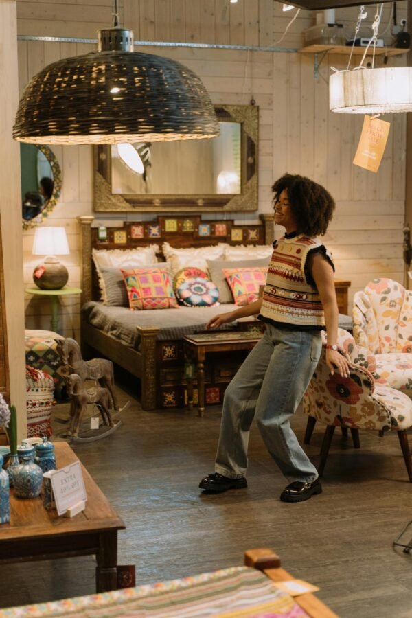 Woman in a boutique enjoying casual fashion with colorful decor around her.