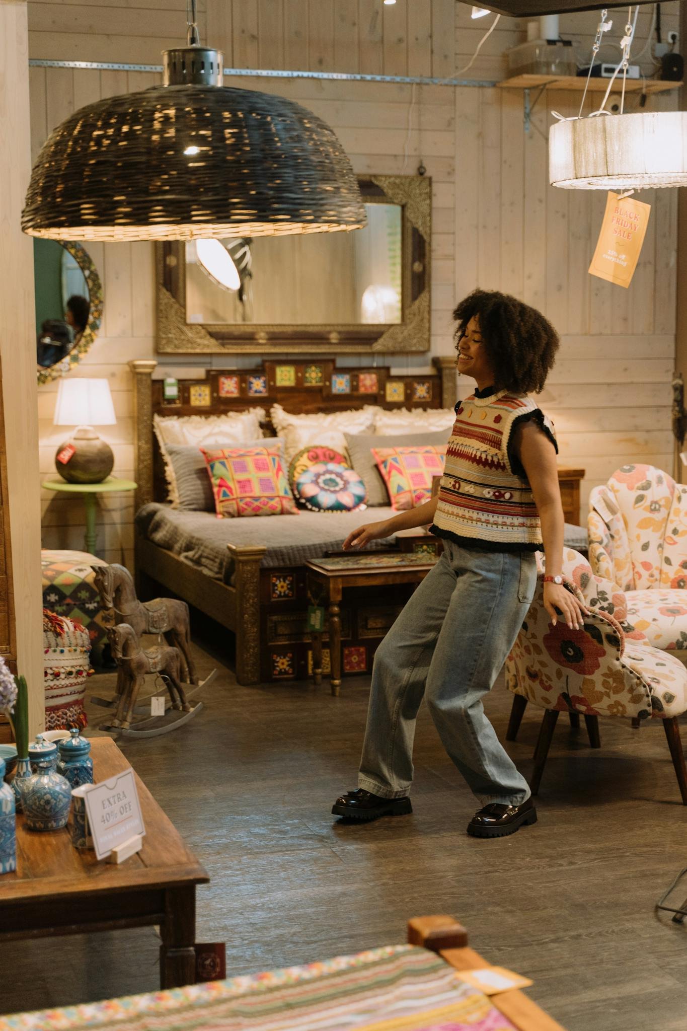 Woman in a boutique enjoying casual fashion with colorful decor around her.
